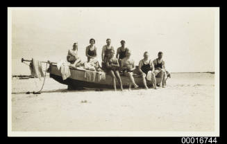 Postcard of eight people with boat at Shark Bay of Western Australia