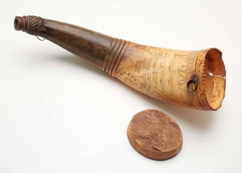 Scrimshaw powder horn engraved with images of ships with a wooden plug