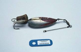 TUNA FISHING LURE, METAL HOOK WITH COLOURED FEATHERS (BLUE, ORANGE AND  PINK) TAPED TO SHAFT WITH WHITE PLASTIC TAPE, TWO ROUND RED INSERTS TO  IMITATE EYES, METAL CABLE ATTACHED TO HOOK –