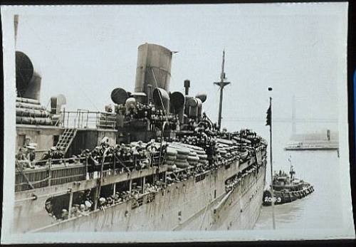 United States troopship pulling away from a wharf