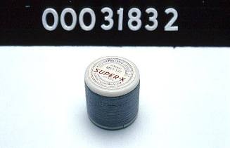 Grey cotton thread on a plastic spool used by tailor Costas Melidis
