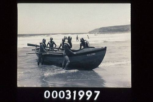 SURFBOAT AKUBRA 2 IN SHALLOWS WITH MEMBERS OF QUEENSCLIFF SURF LIFE SAVING CLUB SURFBOAT CREW