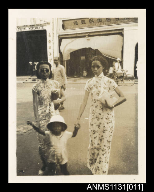 Photograph depicting two women with a child