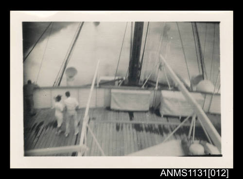 Photograph depicting the waves washing on the bow and deck of a ship