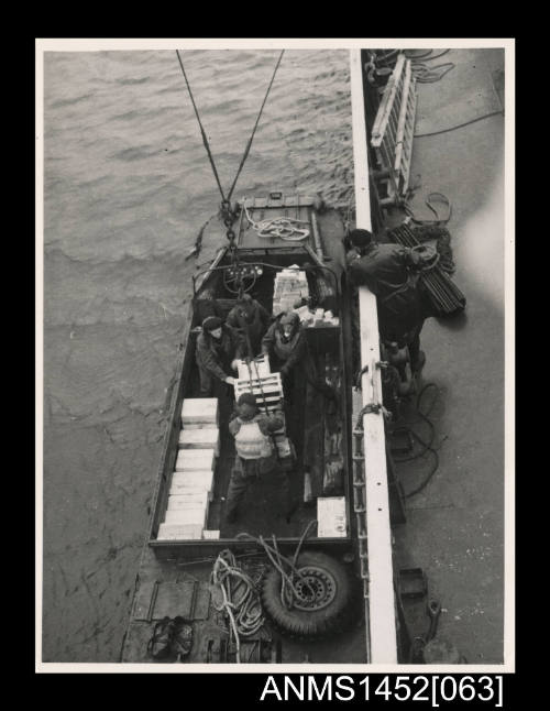 Unloading cargo into a DUKW at Buckles Bay