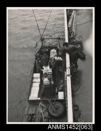 Unloading cargo into a DUKW at Buckles Bay