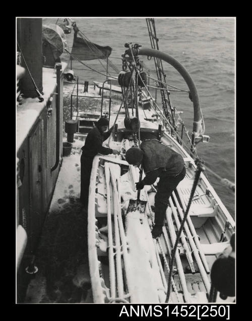 Crew of WYATT EARP shovelling snow from the whaler