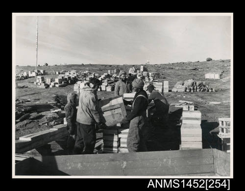 Expedition members unloading cargo during the changeover at Mawson station