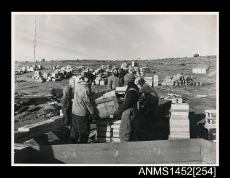 Expedition members unloading cargo during the changeover at Mawson station