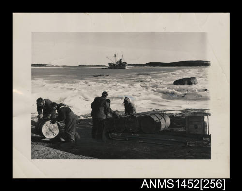 Mawson Station crew members unload fuel from the KISTA DAN