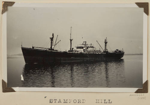 Cargo ship STAMFORD HILL under way at sea off distant shore