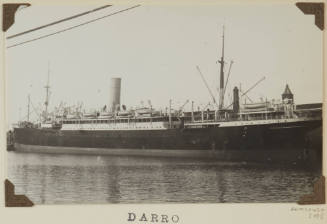 Photograph of  DARRO depicting stern and port side of cargo/passenger ship, berthed at wharf on starboard side