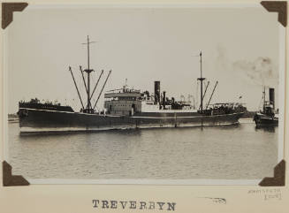 TREVERBYN depicting port side of cargo ship in harbour with line to tug WATO at stern on port side