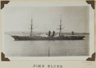 Photograph of  JOHN ELDER depicting port side of cargo ship moored in harbour to buoy centre left