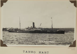 Photograph of  TANGO MARU depicting  starboard side of cargo/passenger ship under way off shore on  port side