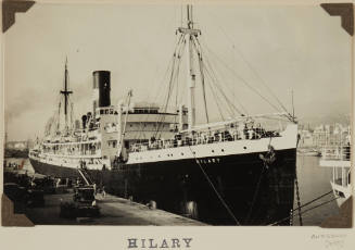 Photograph HILARY depicting bow and starboard  side of cargo/passenger ship berthed at wharf in harbour on the starboard side