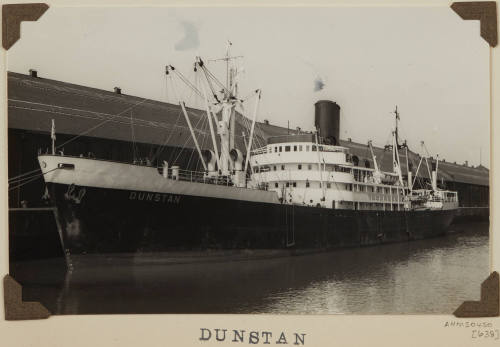 Photograph DUNSTAN depicting port side of  cargo ship berthed at wharf on starboard side