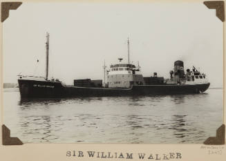 Photograph SIR WILLIAM WALKER depicting port side of coastal cargo ship at anchor off distant shore on starboard side