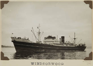 Photograph  WINDSORWOOD depicting  port side of  cargo ship  under way off distant shore on starboard side