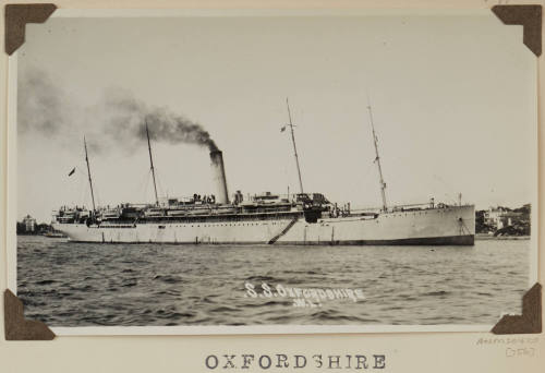 Photograph  OXFORDSHIRE depicting starboard side of passenger ship  at anchor in harour