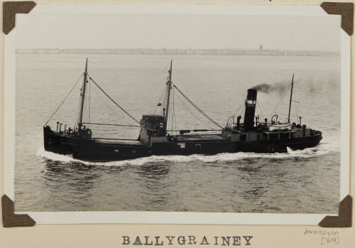 Photograph  BALLYGRAINEY depicting port side view of cargo ship under way off distant shore on starboard  side