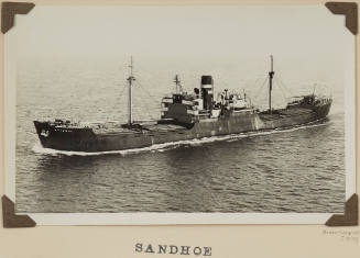 Photograph of SANDHOE depicting port side view  of cargo ship under way at sea