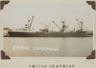 Photograph of  EMPIRE CHARMIAN depicting starboard side view of cargo ship ['bel'-type heavy lift ship]  berthed at wharf on port side