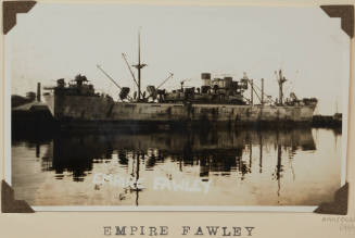 Photograph of  EMPIRE FAWLEY depicting starboard side view of cargo ship  berthed at wharf on port side