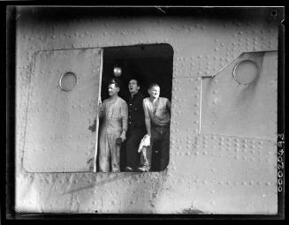Three unidentified men possibly on board RMS QUEEN MARY near Port Jackson in Sydney