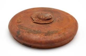 Circular ceramic lid recovered from the wreck of the DUNBAR