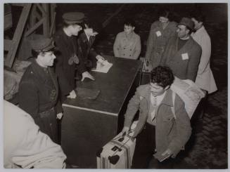 Trieste migrants having their papers checked as they board the CASTELVERDE