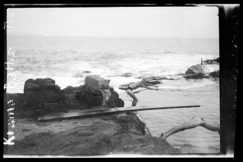 Diving off rocks into an ocean bath