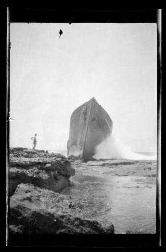 Bow of a wrecked vessel on a rocky seashore