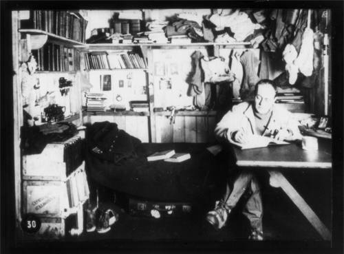 Captain Robert Falcon Scott writing his journal in his den