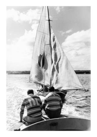 18-foot skiff being towed to start of race