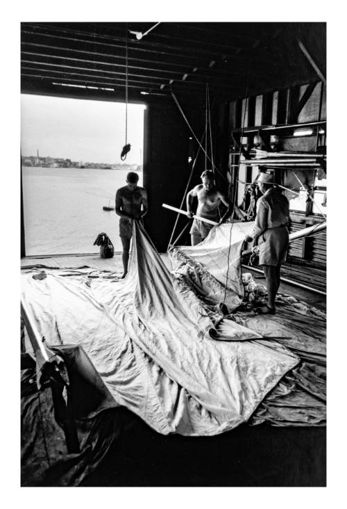 Untitled (three men in a boat shed)