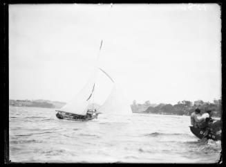 Unidentified skiff  and gaff rigged skiff DAWN, at right, on Sydney Harbour