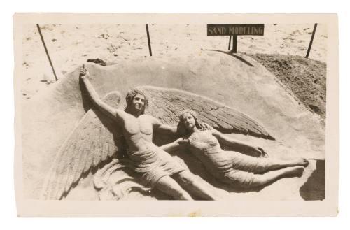 Angel and woman modelled in sand by John Suchomlin, Manly