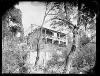 Wooden house with open verandah at an unknown location