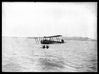 Biplane flying low on Sydney Harbour