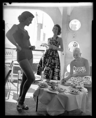 Women posing on ship with lunch