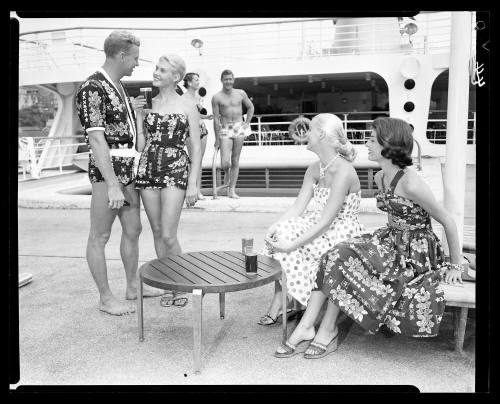 Four models on ship deck