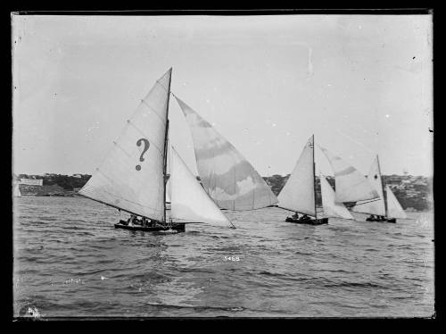 Possibly 14'foot skiffs  on Sydney Harbour, closest vessel has questionmark sail insignia. Inscribed 5468 below headsails of lead skiff.