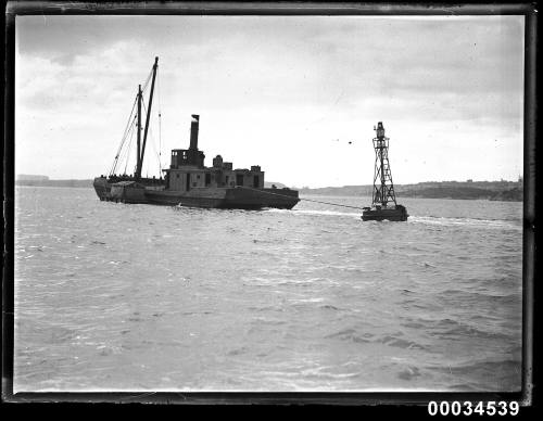 Tugboat passing light buoy in Sydney Harbour