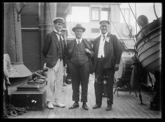 Mr John Roche (left), Mr F. J. S. Young (right) and an unidentified man onboard NAMOI, Sydney Harbour