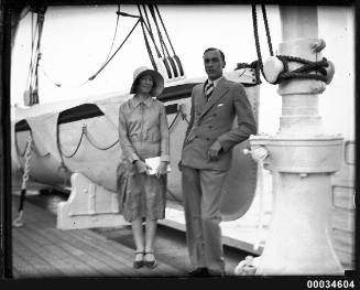 Portrait of a man and woman in front of a lifeboat possibly on board SS ORMISTON