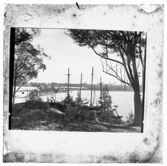 Boatshed, bridge and several yachts, possibly a scene of the Western reaches of Sydney Harbour