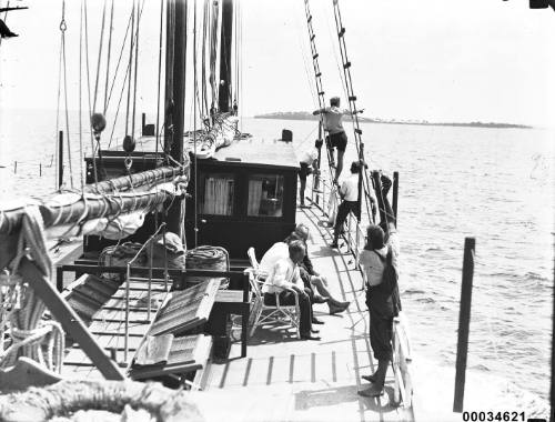 Seven crew on the deck of a sailing vessel