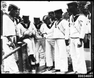 Japanese sailors from the Imperial Japanese Naval Squadron handle a turtle at Taronga Zoo