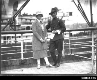 Uniformed man possibly from a military band and a woman on board the ship WELLINGTON